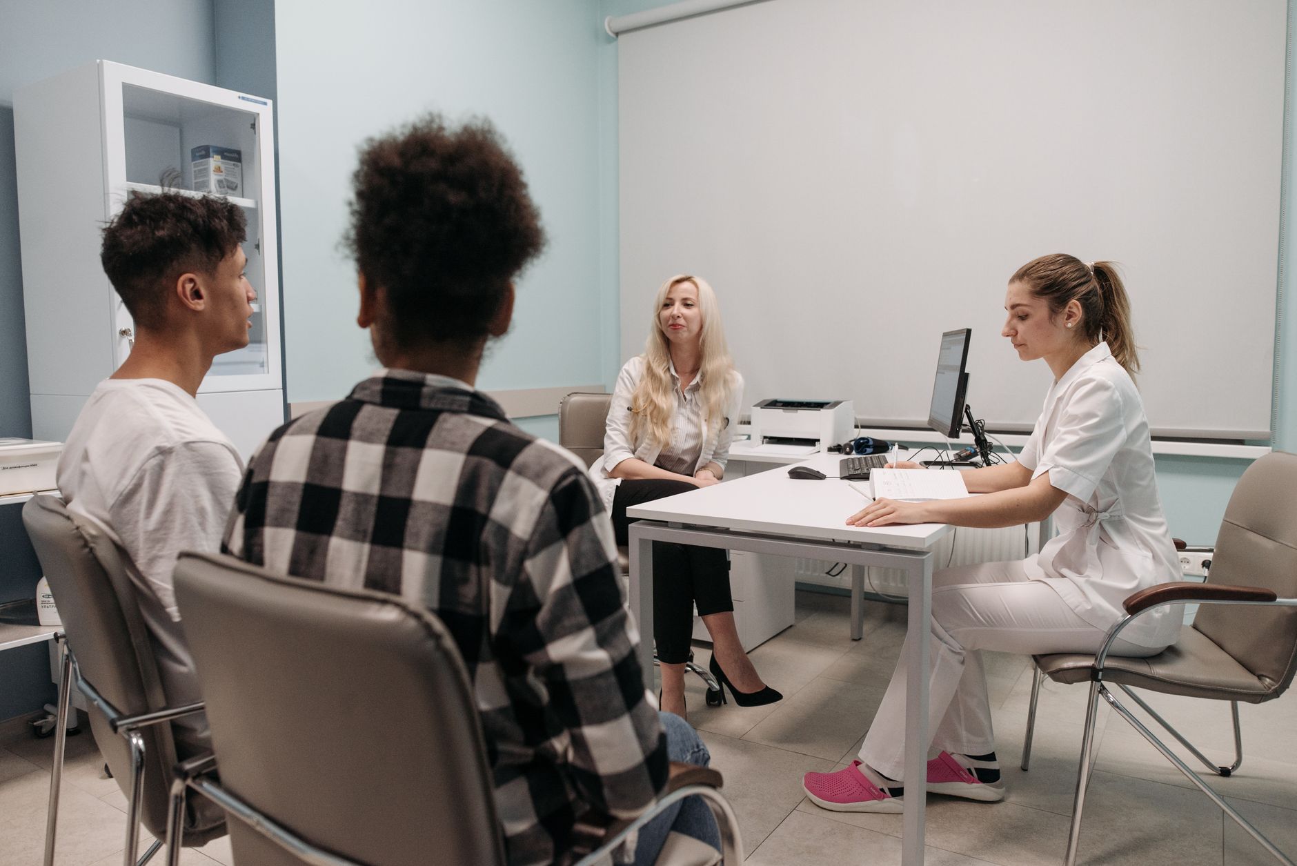 Clinicians talking with patients during a clinic appointment