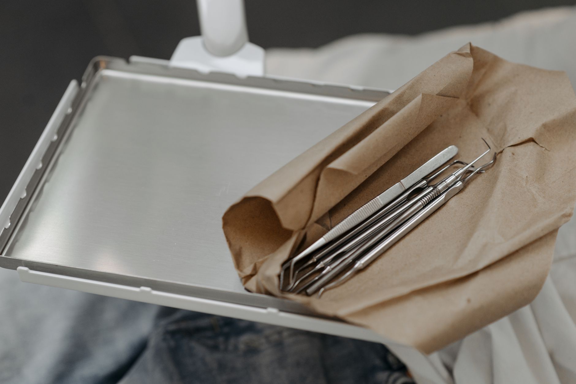 Sterilized dental instruments wrapped and ready on a tray