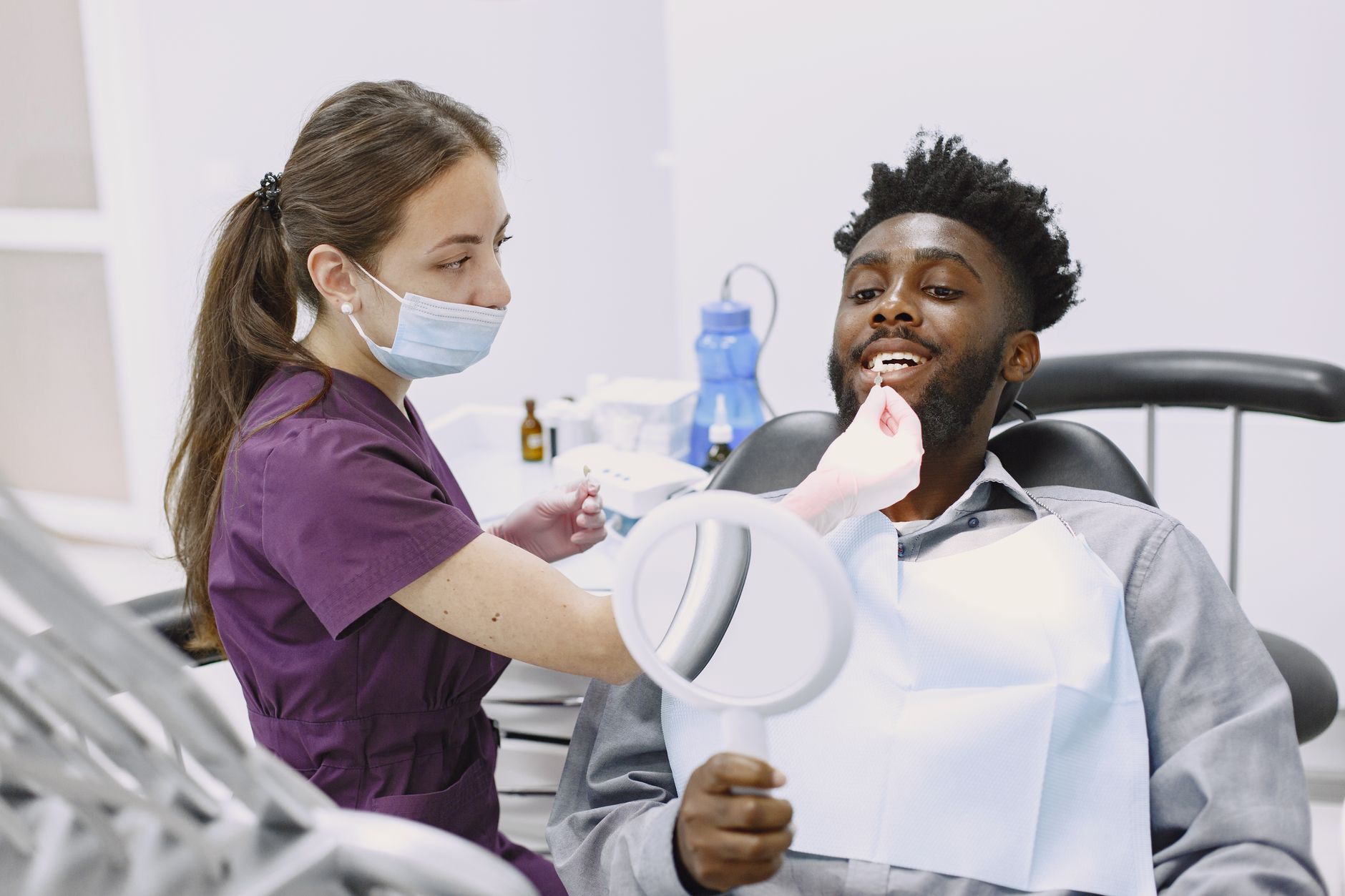 Dental professional checking a patient's teeth in a modern office