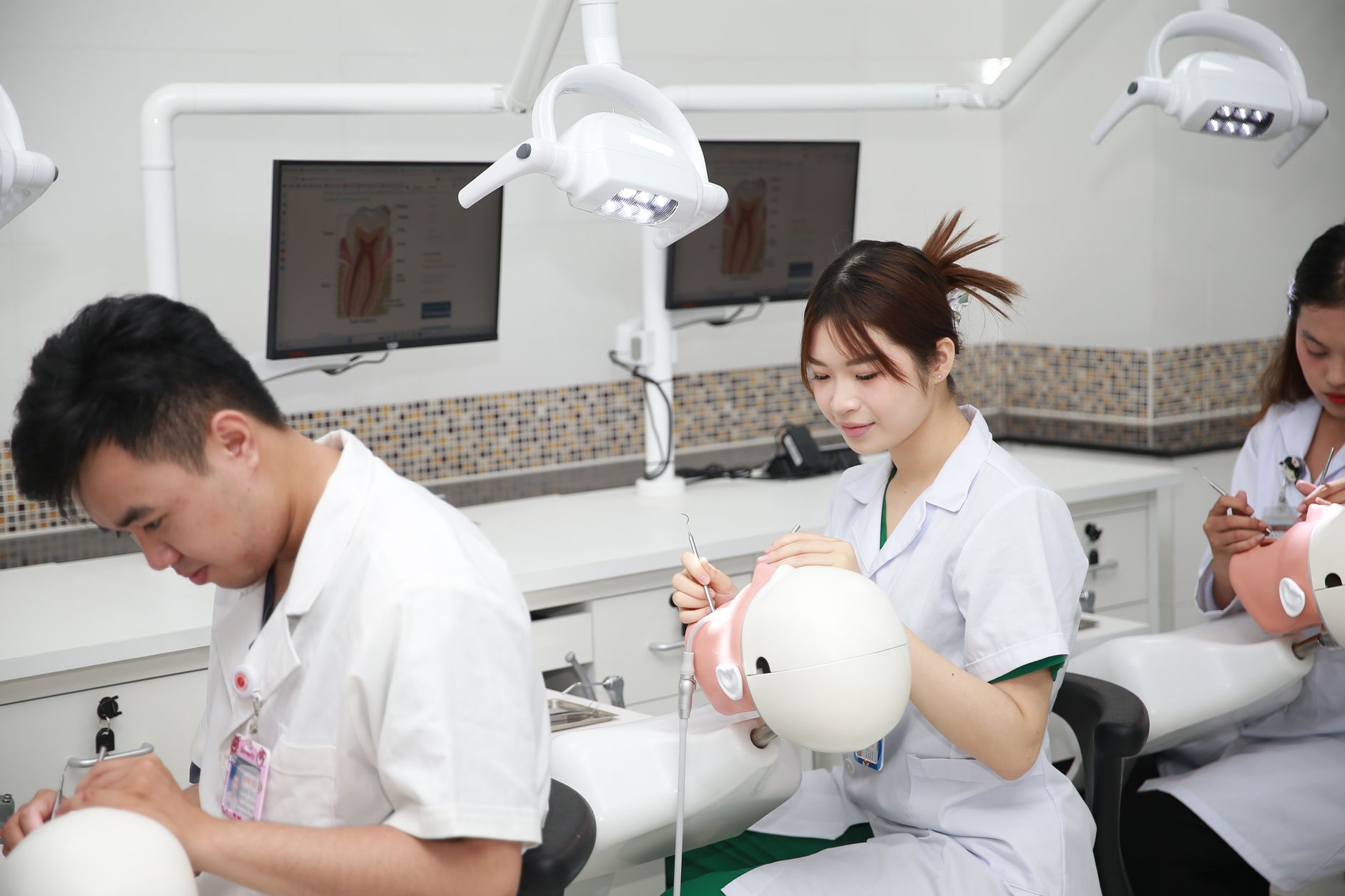 Dental assisting student practicing with dental instruments